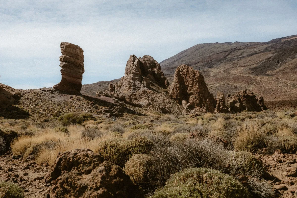 Weathered volcanic rock formations rising from the crater floor at Roques de García, with Teide's slopes behind