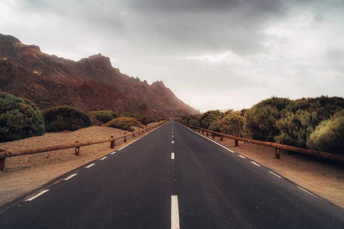 An open road running through the volcanic landscape of southern Tenerife